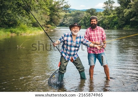 Men hobby and recreation. Fishermen successful catch fish. Fisher retirement. Retired businessman in suit with fishing rod. Male friendship. Granddad and drandson fishing. Happy excited man friends. Royalty-Free Stock Photo #2165874965