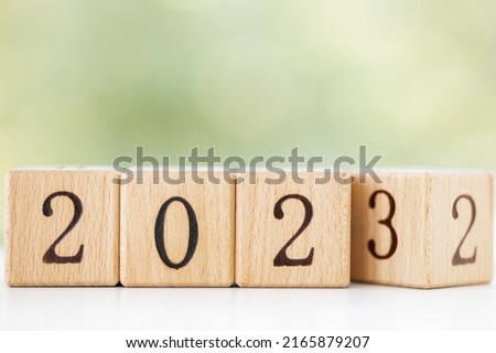 wooden block of 2022 to 2023, New Year Resolutions, business concept