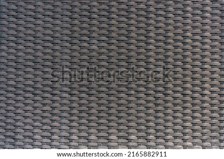 The sight of Backrest section of gray mesh chair.
