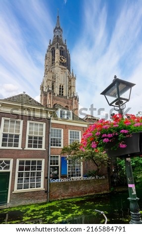 New church tower over Delft canals, Netherlands (translation "Tourist information point")