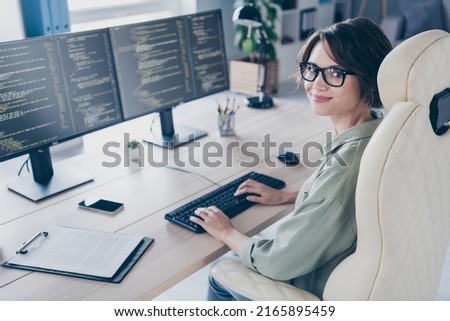 Photo of skilled web designer sitting chair typing keyboard look camera office room workplace
