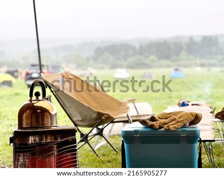 Rain campground stoves and outdoor chairs