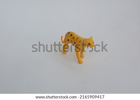 Yellow leopard shaped toy made of plastic photo