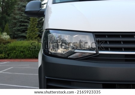 Modern Cargo Van front headlight with headlight washer. Cargo Van light. Modern Car front headlight. Royalty-Free Stock Photo #2165923335