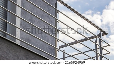 fence. chrome stainless steel fence on balcony  Royalty-Free Stock Photo #2165924959