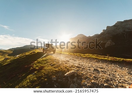 4x4 off-road car driving along a mountain track on a sunny day. car adventure trip Royalty-Free Stock Photo #2165957475