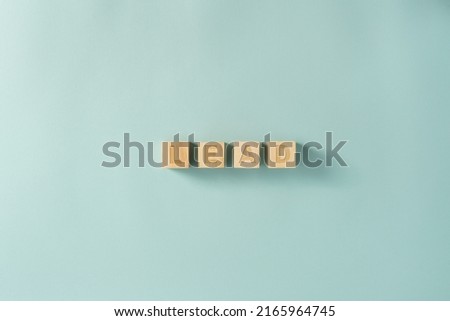 LEAD word on wooden cubes on the blue background, sign made by blocks