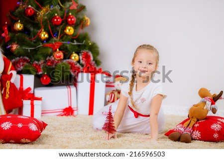 New Year's Concert. Adorable girl near a Christmas tree with presents. new year