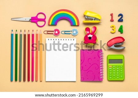 Frame from school and office supplies Paper clips, pens, calculator, sharpener, notepad, stapler isolated on beige background Flat lay Top view Back to school, education concept Mock up Copy space