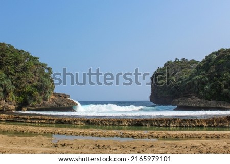 The beauty of the Batu Bengkung beach scenery with big waves and a beautiful lagoon. Located in Malang, East Java Province, Indonesia.