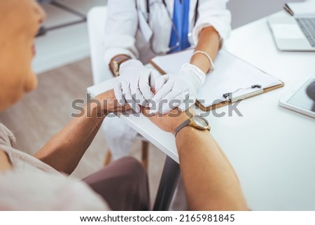 Closeup shot of an unrecognizable female doctor holding a patient's hand in comfort during a consultation inside her office. Cropped shot of a senior woman holding hands with a nurse