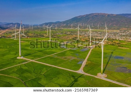 Landscape with Turbine Green Energy Electricity, Windmill for electric power production, Wind turbines generating electricity on rice field at Phan Rang, Ninh Thuan, Vietnam. Clean energy concept. Royalty-Free Stock Photo #2165987369