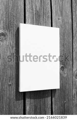 White stretched canvas mockup on grey wooden wall