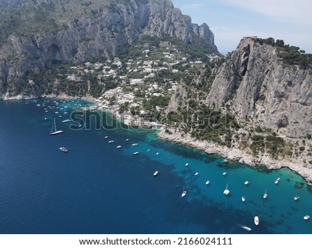 Aerial view of Capri, an island on the south side of the Gulf of Naples in the Campania region of Italy. Drone view of Faraglioni di Capri. 