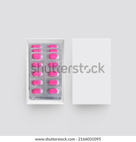 Package with medicinal pills on gray background. top view