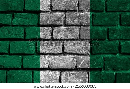 An image of the Nigeria flag on a wall with a crack. Background.