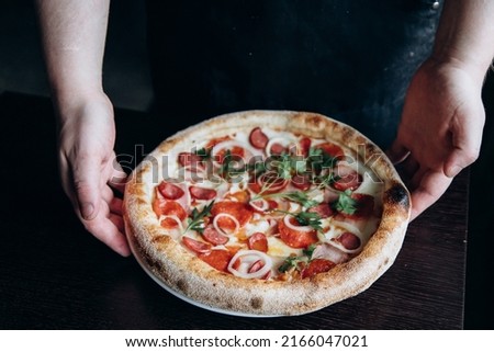 Appetizing hot pizza with golden crust cut into slices