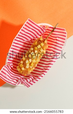 Top View Delicious Crunchy Korean Style Chunky Potato Corn Dogs with Batter and Fried Potatoes. Isolated on Cream Background with Copy Space for Text Royalty-Free Stock Photo #2166055783
