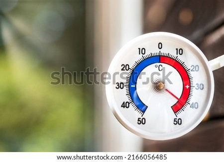 Outdoor thermometer with celsius scale shows extreme hot temperature 42 degree - summer heatwave concept Royalty-Free Stock Photo #2166056485
