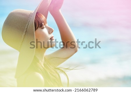 Young Asian woman enjoying the resort on the beach Royalty-Free Stock Photo #2166062789