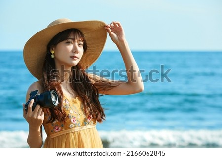 Young Asian woman enjoying the resort on the beach