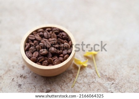 brown roasted coffee bean in bowl for making drink in healthy morning. SELECTIVE FOCUS.