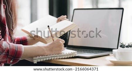 Cropped image Young female freelancer blogger influencer writing notes on her diary