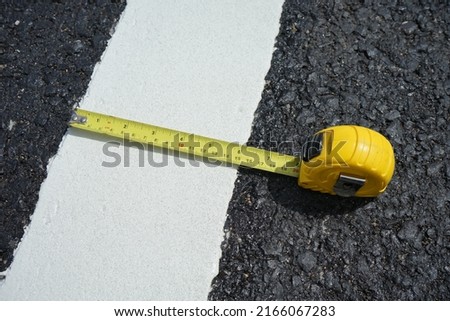 Checking the width of the road marking paint