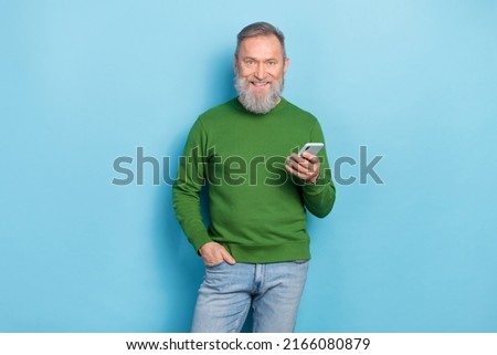 Photo of middle aged man blogger use gadget technology search network news isolated blue color background