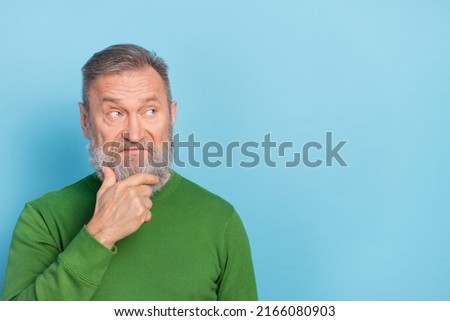 Photo of skeptic middle aged man touch chin empty space try decide brainstorming idea isolated blue color background
