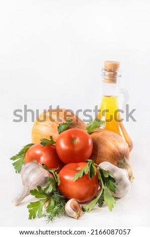pumpkin, tomatoes and other ingredients for a vegetable dish on a light background