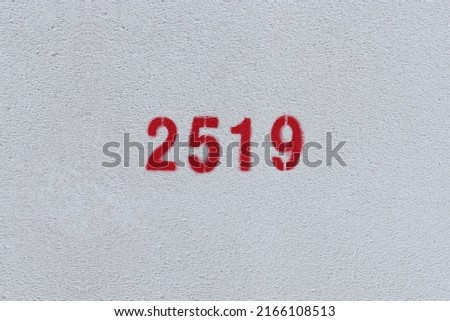 Red Number 2519 on the white wall. Spray paint.
