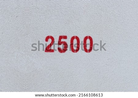 Red Number 2500 on the white wall. Spray paint.
