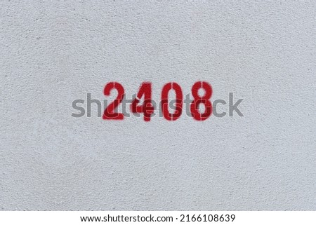 Red Number 2408 on the white wall. Spray paint.
