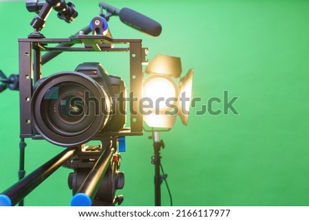 camera,microphone, lights and a green screen