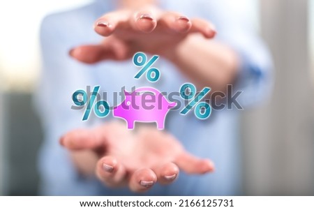 Interest rates concept between hands of a woman in background