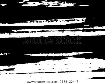 Grunge is black and white. Texture of black strokes on a white background. Abstract chaotic movements with a dry brush. Monochrome pattern of worn surface