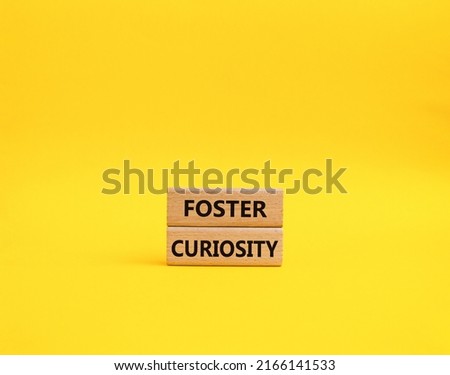 Foster curiosity symbol. Concept word Foster curiosity on wooden blocks. Beautiful yellow background. Business and Foster curiosity concept. Copy space . Conceptual image Royalty-Free Stock Photo #2166141533