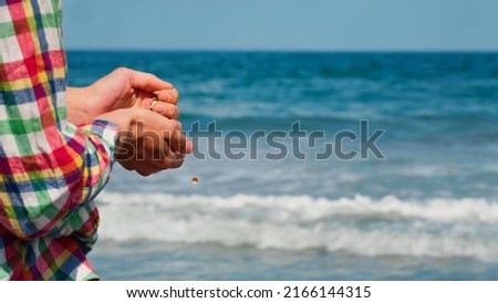 Man having fun on the beach at sunset. Activities on holiday on the sea