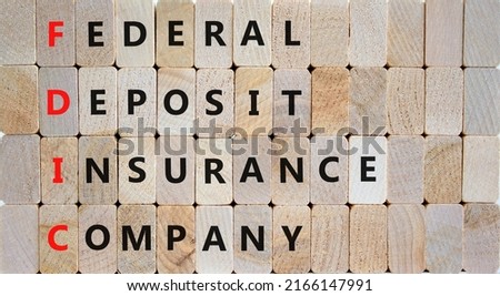 FDIC federal deposit insurance corporation symbol. Concept words FDIC federal deposit insurance corporation on blocks on wooden background. Business FDIC federal deposit insurance corporation concept.