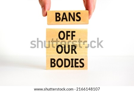Bans off our bodies symbol. Concept words Bans off our bodies on wooden blocks on beautiful white table white background. Women rights concept. Business social issues and bans off our bodies concept.
