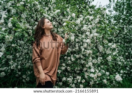 beautiful girl in blooming apple tree aroma of flowers outdoor nature