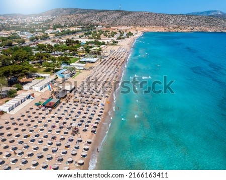 Aerial view of the beach resort at Varkiza, south Athens coast, Attica, Greece, with lined up umbrellas next to the turquoise sea Royalty-Free Stock Photo #2166163411
