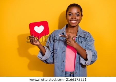 Photo of young pretty girl indicate finger promo app select recommend click isolated over yellow color background