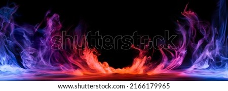 Dramatic smoke and fog in contrasting vivid red, blue, and purple colors. Vivid and intense abstract background or wallpaper. Royalty-Free Stock Photo #2166179965
