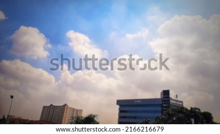 Defocused abstract background of
View of clear sky, above office building.