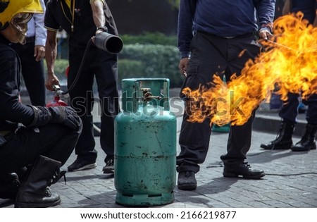 practice Firefighters fighting a fire operation with high pressure portable extinguisher to fire surround gas tube with smoke in fire figther training day