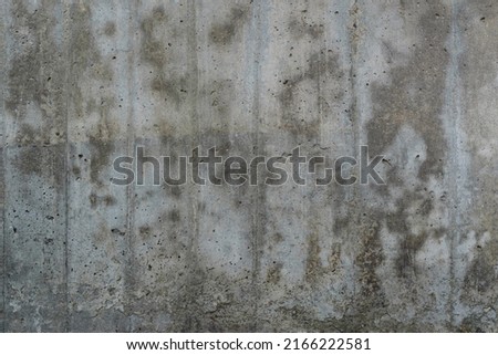 Texture of old reinforced concrete surface. Flat reinforced concrete surface with traces of wooden formwork, covered with dark spots, background, high resolution.