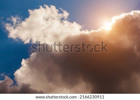 Summer cloudy blue sky background with sunlight. Panoramic view with beautiful clouds. Horizontal cloudscape. Toned. Design element. Copy space.
