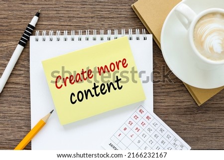 Create more content. written on a sticker on the table